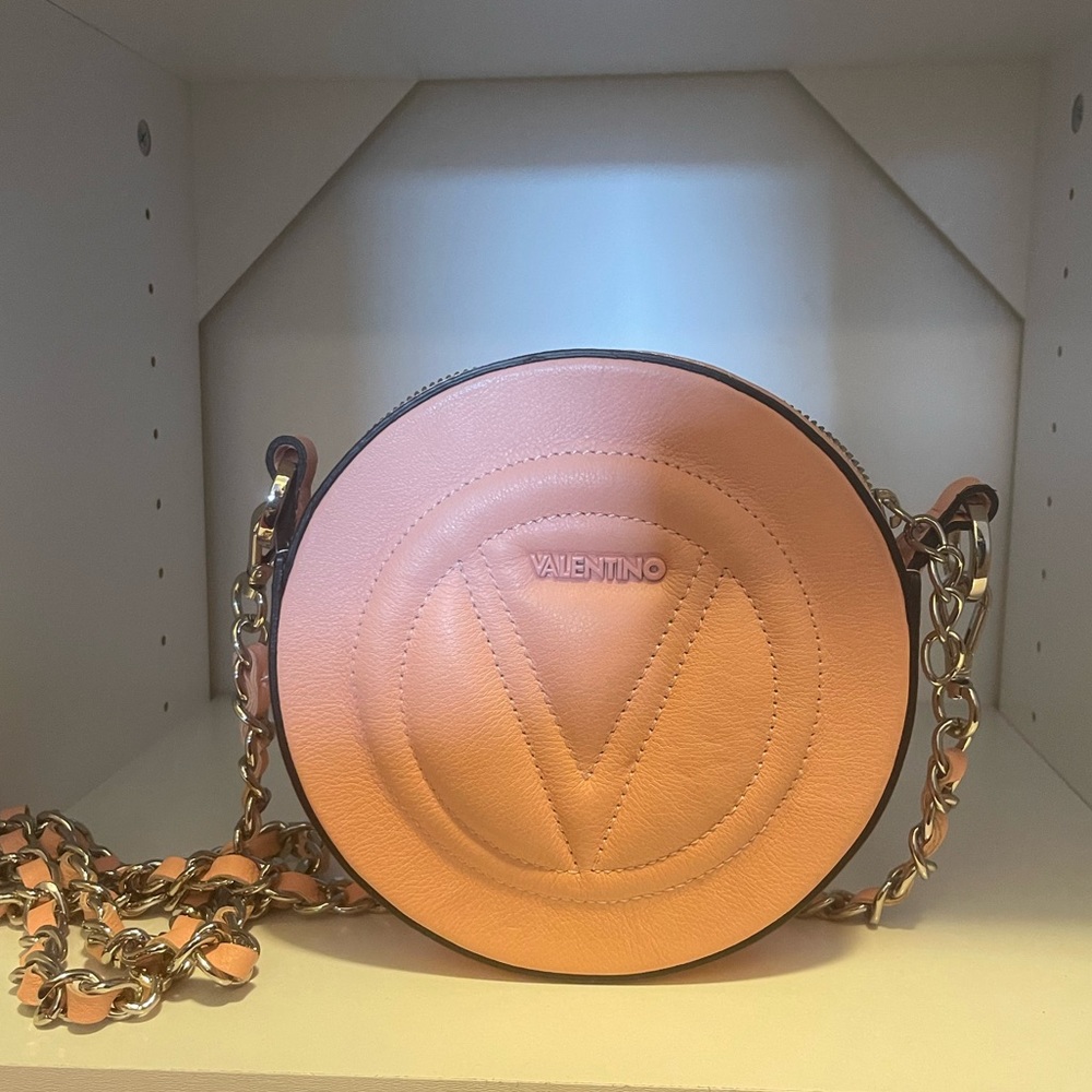 Small Valentino crossbody purse. Light peach color